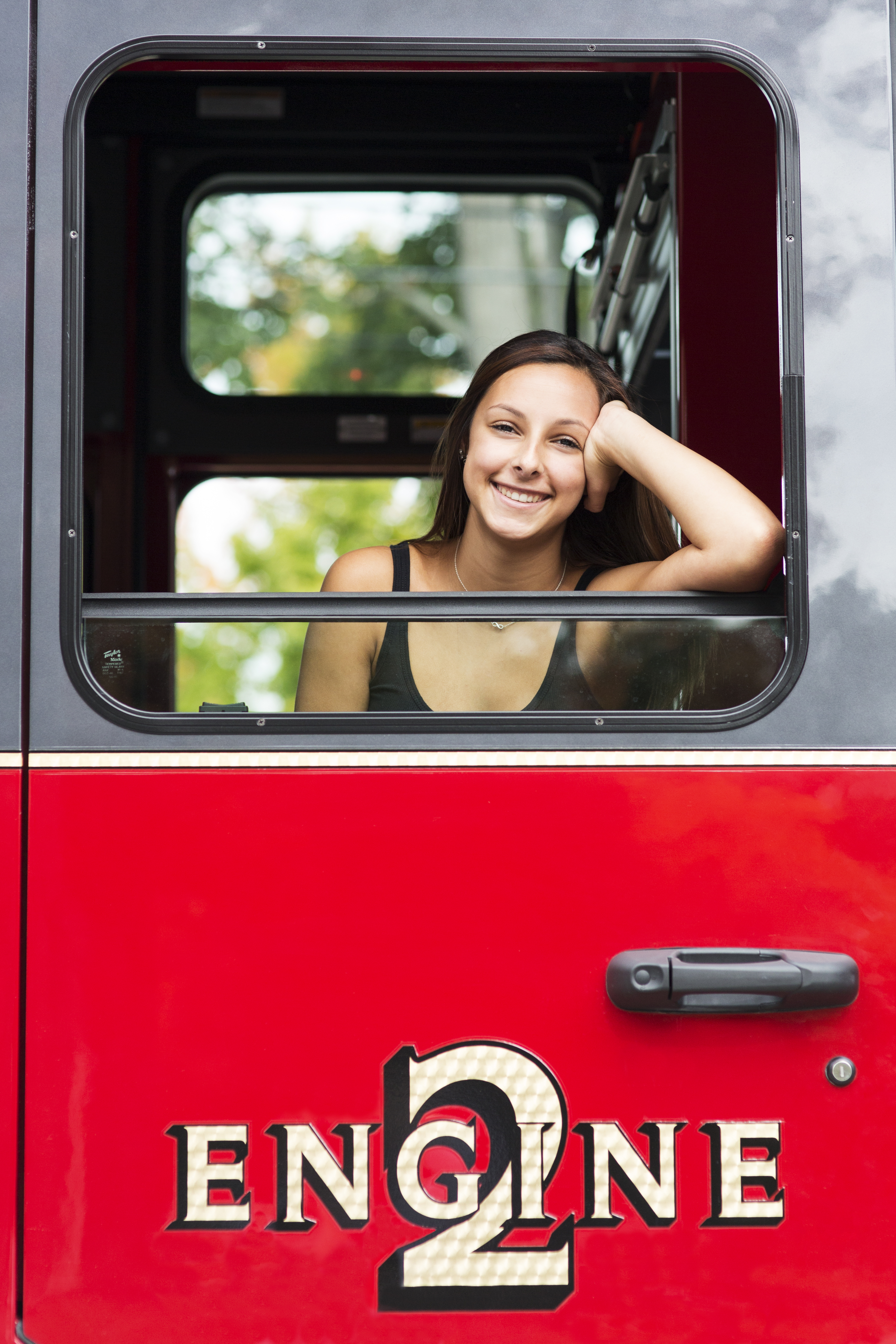 senior girl photos looking out fire engine window