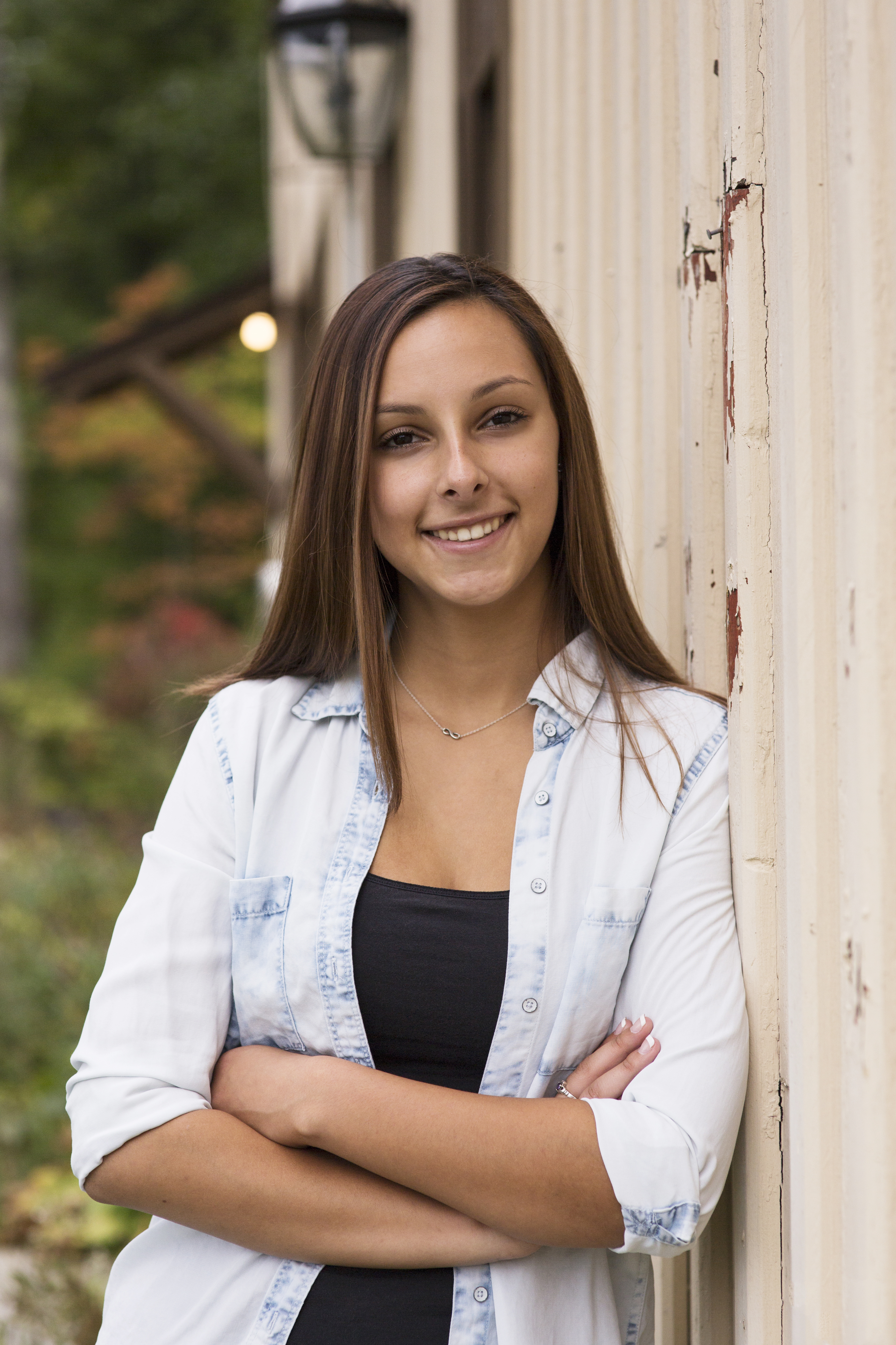 senior headshot rusty white building girl with brown hair