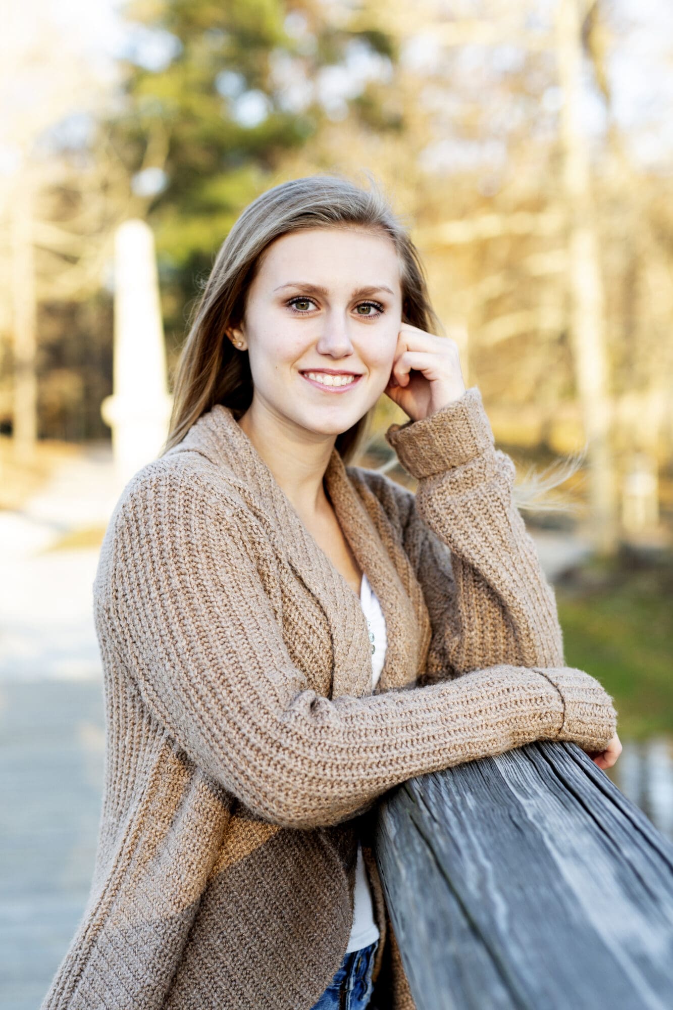 senior girl portrait leaning on elbow on wooden bridge